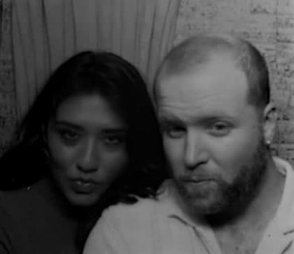 Brenden and Nicole posing in a photo booth